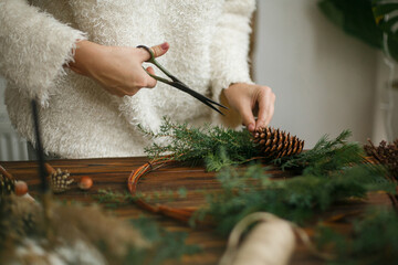 Making rustic christmas wreath, holiday advent.