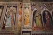 Church of San Miniato al Monte, in Florence, Italy. Detail of the paintings and frescos from the gothic medieval period on the side walls of the naves
