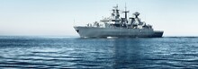Large Grey Modern Warship Sailing In Still Water. Clear Blue Sky. Baltic Sea, Germany. Global Communications, International Security Theme. Panoramic Image