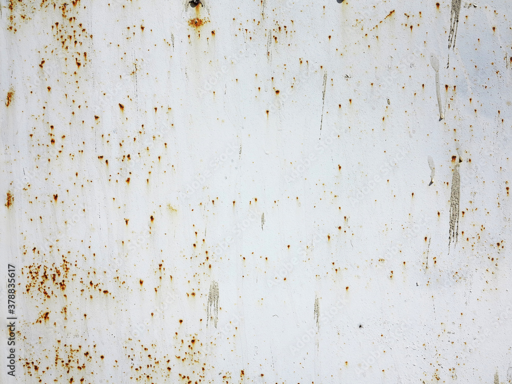 Bright multi-colored paint on rusty metal surface. Rusty metal wall, old sheet of iron covered with rust with multi-colored paint. As textured authentic background for your project