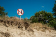 © blinova - Banning coastal round navigation of the river sign. Divergence and overtaking are prohibited. Safety of navigation on inland waterways. A warning on a river on background of wild nature and the sky