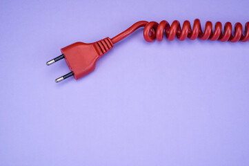 Canvas Print - Top view  of the red plug on the purple  surface