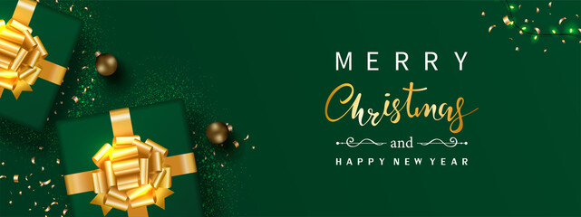 Christmas banner. Gift box decorated with gold bow-ribbon, Christmas ball, confetti, sparking light isolated on green background. Xmas holiday ornament. Luxury style. Top view. Vector illustration.