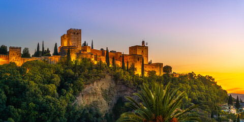 Granada, Spain. October 17th, 2020. View at sunset from below of the buildings and towers of the Alhambra illuminated by artificial lights.