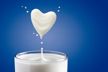 Milk Pouring Into Glass And Heart Shape From Milk