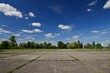© Vaclav Pospisil - Concrete sports area. A grassy sports area of the school playground. Ready for sports. Background with blue sky and clouds.