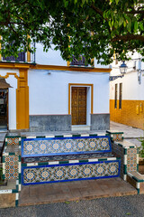 Wall Mural - Bench decorated with painted tiles in a park in the old town of Seville, Andalucia, Spain.