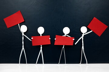 Wall Mural - Group of stick man figure holding red placards in black background. Activism, protest, demonstration, social movement and freedom of expression concept.