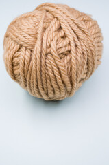 Canvas Print - Vertical shot of a ball of yarn on a blue surface