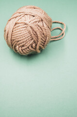 Canvas Print - Vertical shot of a ball of yarn on a blue surface