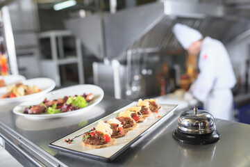 Wall Mural - the distribution table in the kitchen of the restaurant. the chef prepares a meal on the background of the finished dishes.