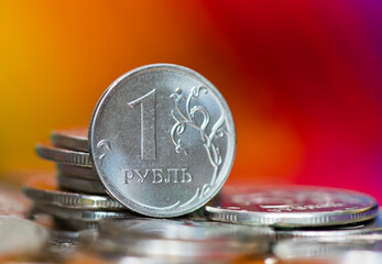 Russian money. One rouble. Coins against colorful background