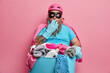© wayhome.studio  - House cleaning and laundry time concept. Stunned bearded man in superhero costume busy doing washing poses with basin detergents against pink studio background. Busy male cleaner works at home