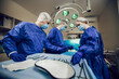 © Olha - Portrait of team of surgeons at work. Three doctors in medical masks in operations begin to operate on the patient. Doctors in surgery, treatment and medicine