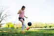 © Mego-studio - Young female soccer player practicing on field.