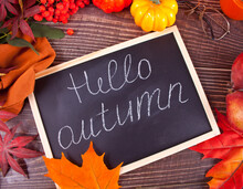 Chalkboard With Hello Autumn Text. Composition With Pumpkin, Autumn Leaves And Red Pears. Cozy Autumn Mood Concept.