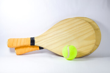 Beach tennis racket and ball with white background