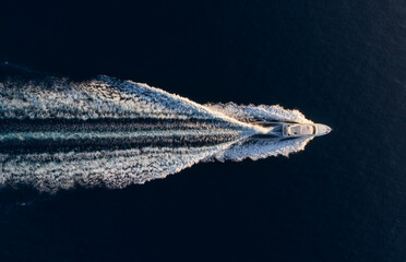 Wall Mural - aerial view on fast boat on blue mediterranean sea at sunny day. fast ship on the sea surface. seasc