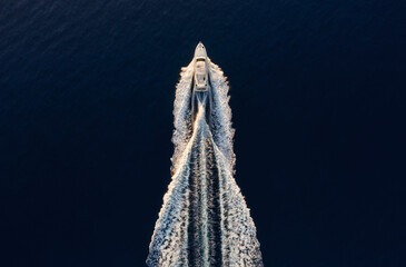Wall Mural - aerial view on fast boat on blue mediterranean sea at sunny day. fast ship on the sea surface. seasc