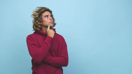 Wall Mural - Young cool australian man looking sideways with doubtful and skeptical expression