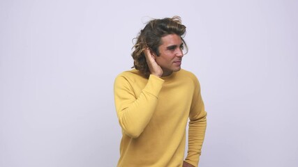 Wall Mural - Young cool australian man trying to listening a gossip