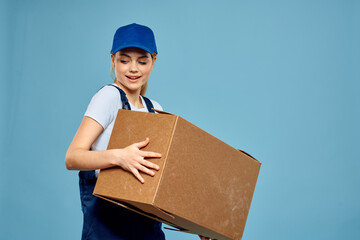 Woman working form box in hands packing delivery service blue background