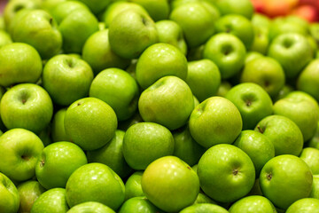 Background of apples fruits. Selective focus. Fresh Juicy apples Heap on Market Stall red apples in the market. Blurred background.