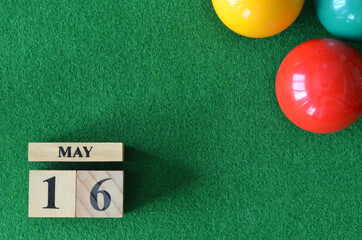 May 16, number cube with balls on snooker table, sport background.