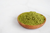 Fototapeta Mapy - Moringa powder in wooden bowl on white background. Healthy product, superfood, vitamin Moringa Oleifera