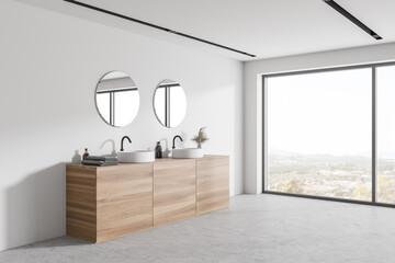 Double sink in white and wooden bathroom corner