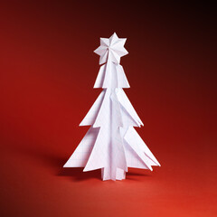 Wall Mural - Christmas trees made of paper on red background. Christmas card