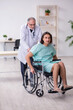 © Elnur - Young male patient in wheel-chair and experienced doctor traumatologist