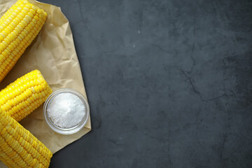 Freshly made fragrant ear of corn with salt. Farm snack of fresh corn. Healthy breakfast and healthy lifestyle concept.