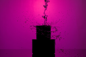 Wall Mural - silhouette of a black bottle with a men's perfume in  water drops