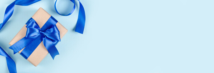 gift box on blue background composition, present with ribbon and bow. flat lay and top view photo wi