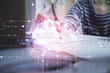 © peshkova - Multi exposure of writing hand on background with brain hologram. Concept of self learning.