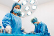 © Art_Photo - Professional anesthesiologist doctor medical team and assistant preparing patient to gynecological surgery performing operating with surgery equipment in modern hospital operation emergency room