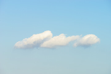 Puffy white clouds against blue sky background