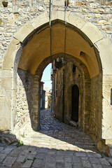 A narrow street among the old houses of Baselice, a small town in the province of Benevento, Italy.