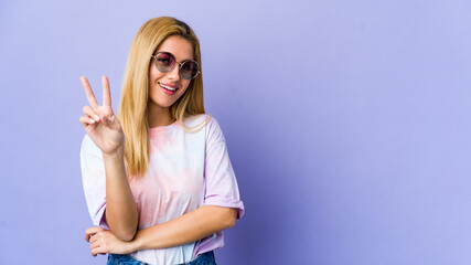 Young hipie woman with glasses isolated on purple background showing number two with fingers.