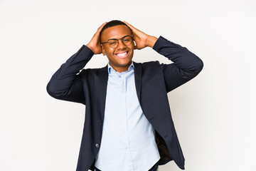 Wall Mural - Young business latin man isolated on white background laughs joyfully keeping hands on head. Happiness concept.