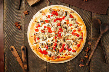 Wall Mural - Top view on pizza with mushrooms and tomatoes