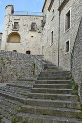 A narrow street among the old houses of San Marco dei Cavoti, a small town in the province of Benevento, Italy.