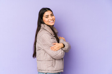 Wall Mural - Young indian woman isolated on purple background laughing and having fun.