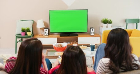 Wall Mural - Three females watch green TV