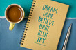 dream, hope, believe, dare, risk, try - creativity, inspirational and motivational concept, personal development,  handwriting in a spiral sketchbook with a cup of coffee