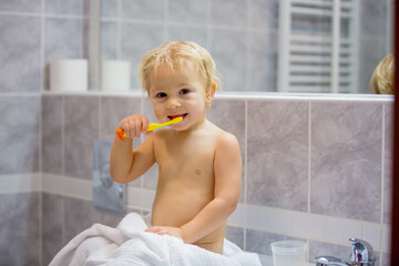 Sticker - Sweet toddler boy, brushing his teeth in bathroom in the evening after bath