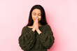 © Asier - Young chinese woman isolated on a pink background holding hands in pray near mouth, feels confident.