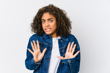 Wall Mural - Young african american woman rejecting someone showing a gesture of disgust.