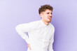 © Asier - Young blond curly hair caucasian man isolated suffering a back pain.